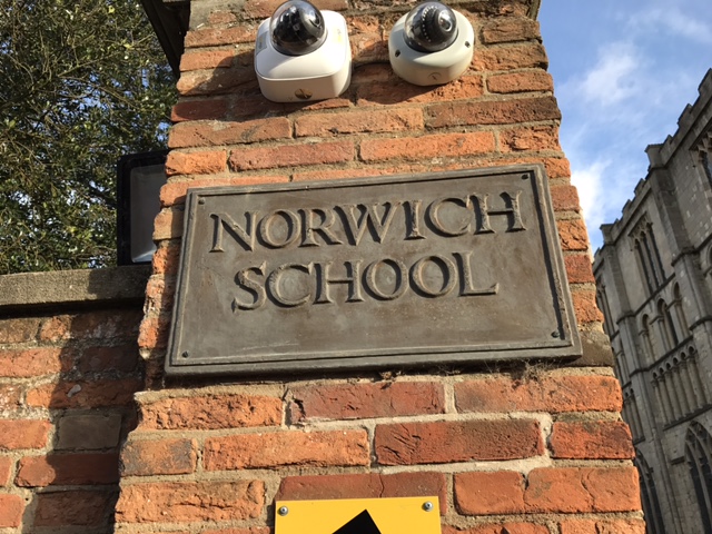 Norwich School sign mounted on a historic brick wall